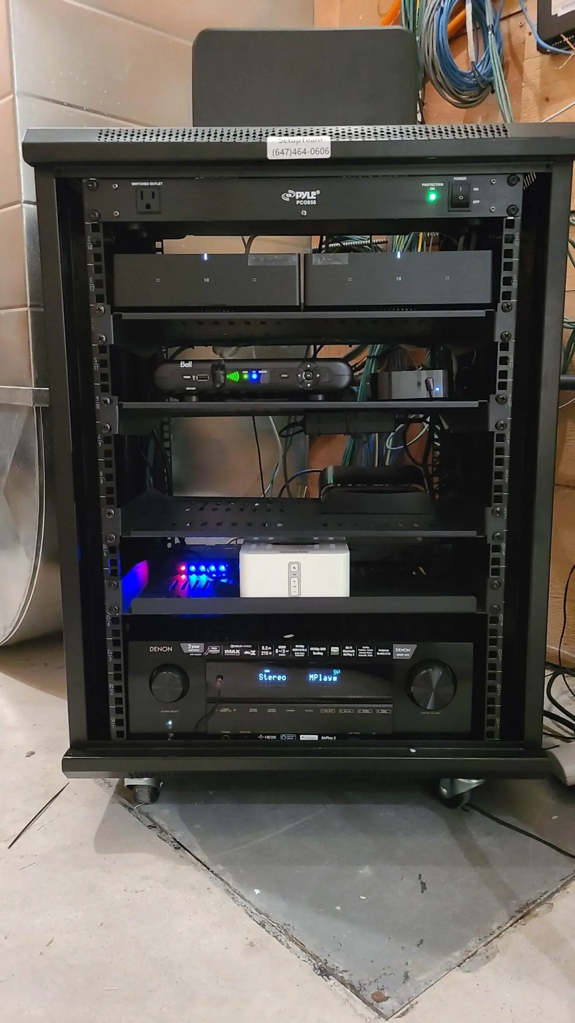 SetupTeam-installed AV equipment rack with Denon receiver, Sonos amplifier, network switch, and Bell receiver in a Vaughan home theatre