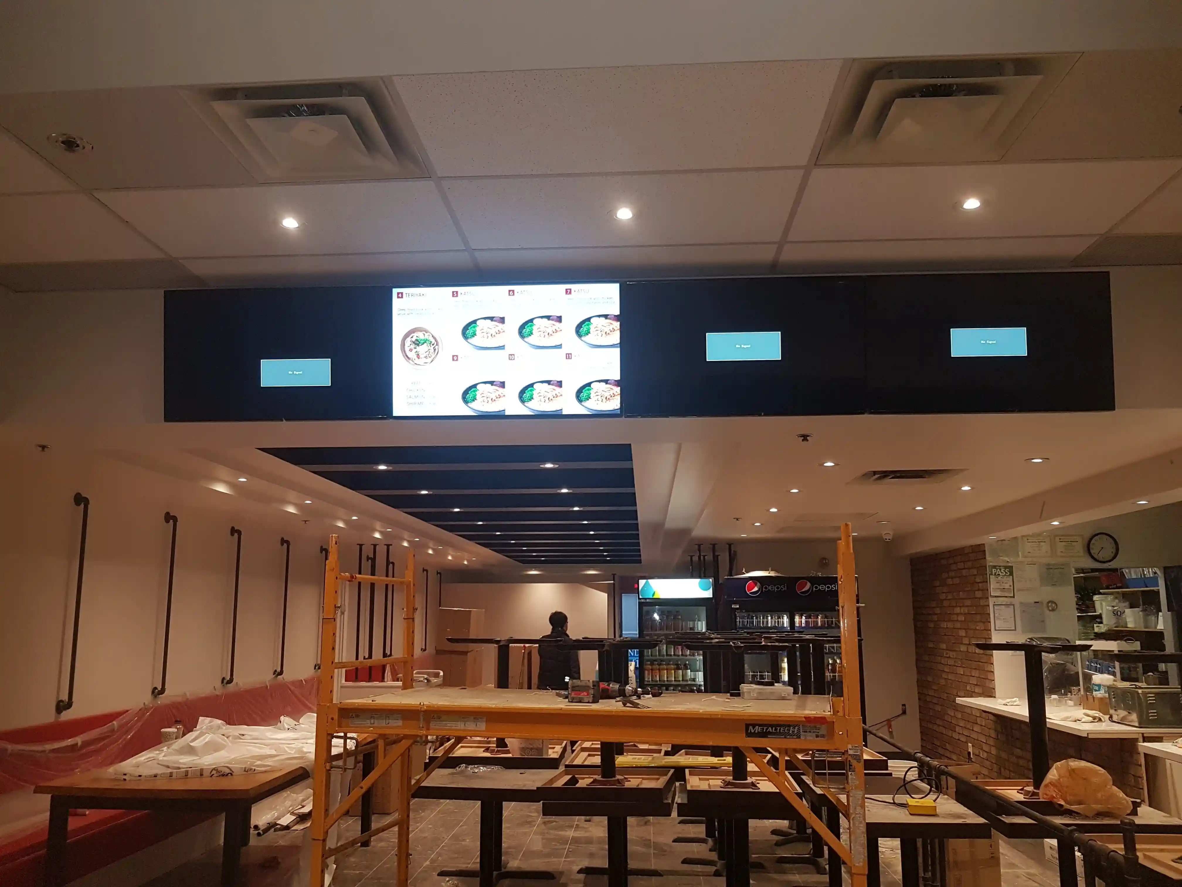 Multiple TVs mounted in a Toronto bar for sports viewing