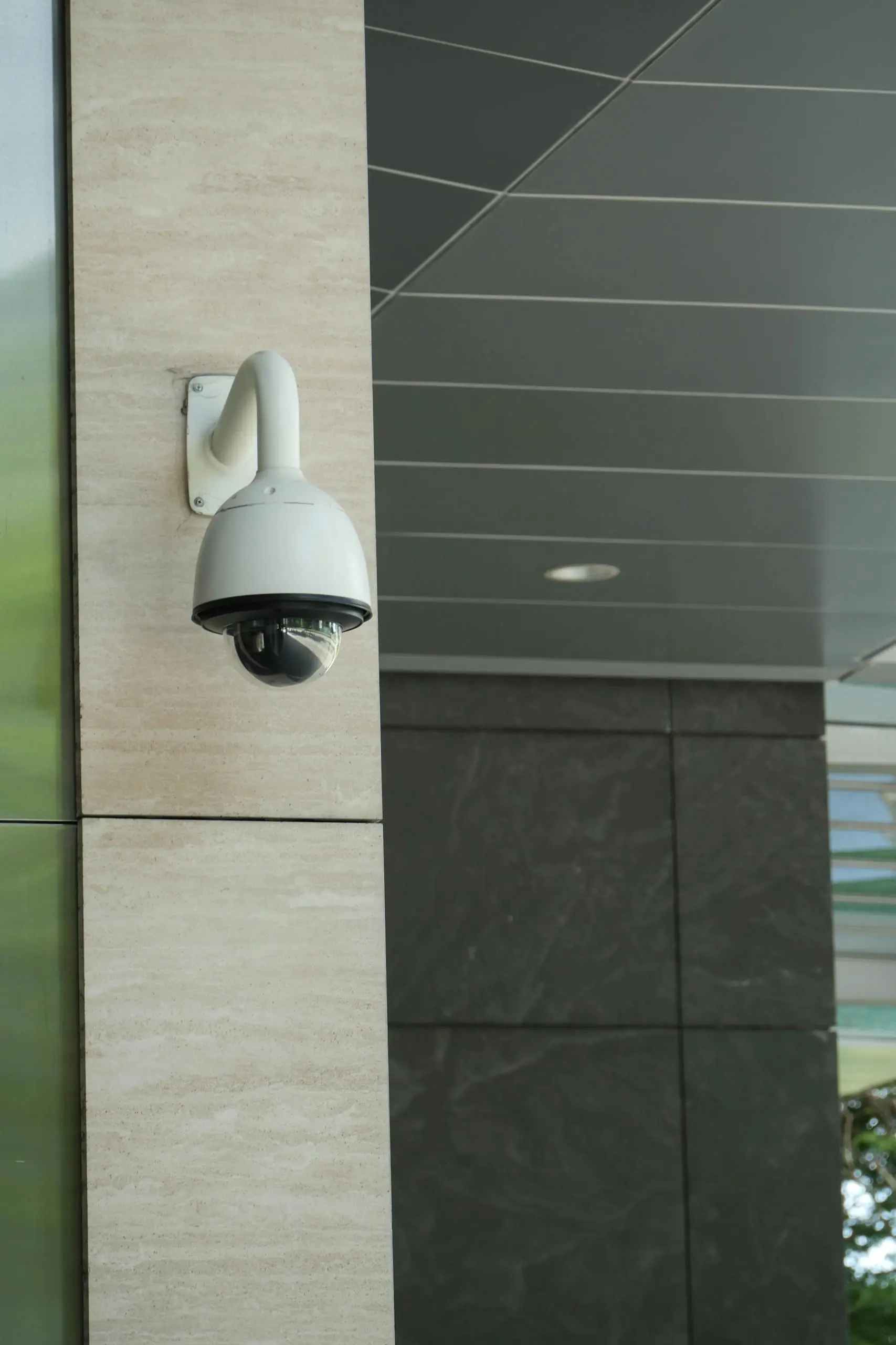 Mounted security camera on a modern commercial building exterior