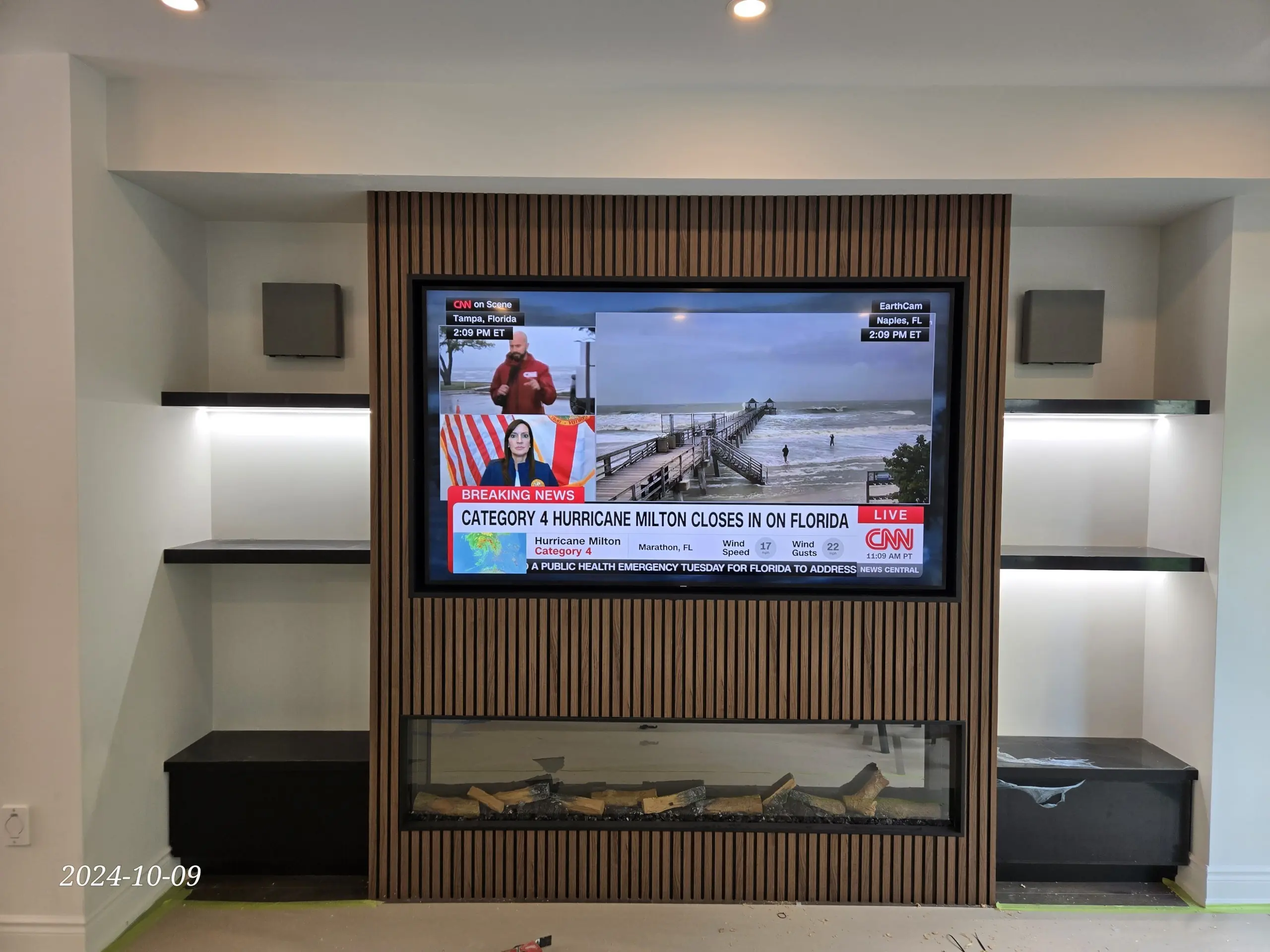 Samsung Frame TV on custom slat media wall with fireplace in Aurora home, no visible wires