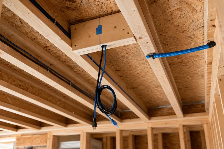 Ceiling projector drop position roughed in with HDMI and Cat6 cables before drywall