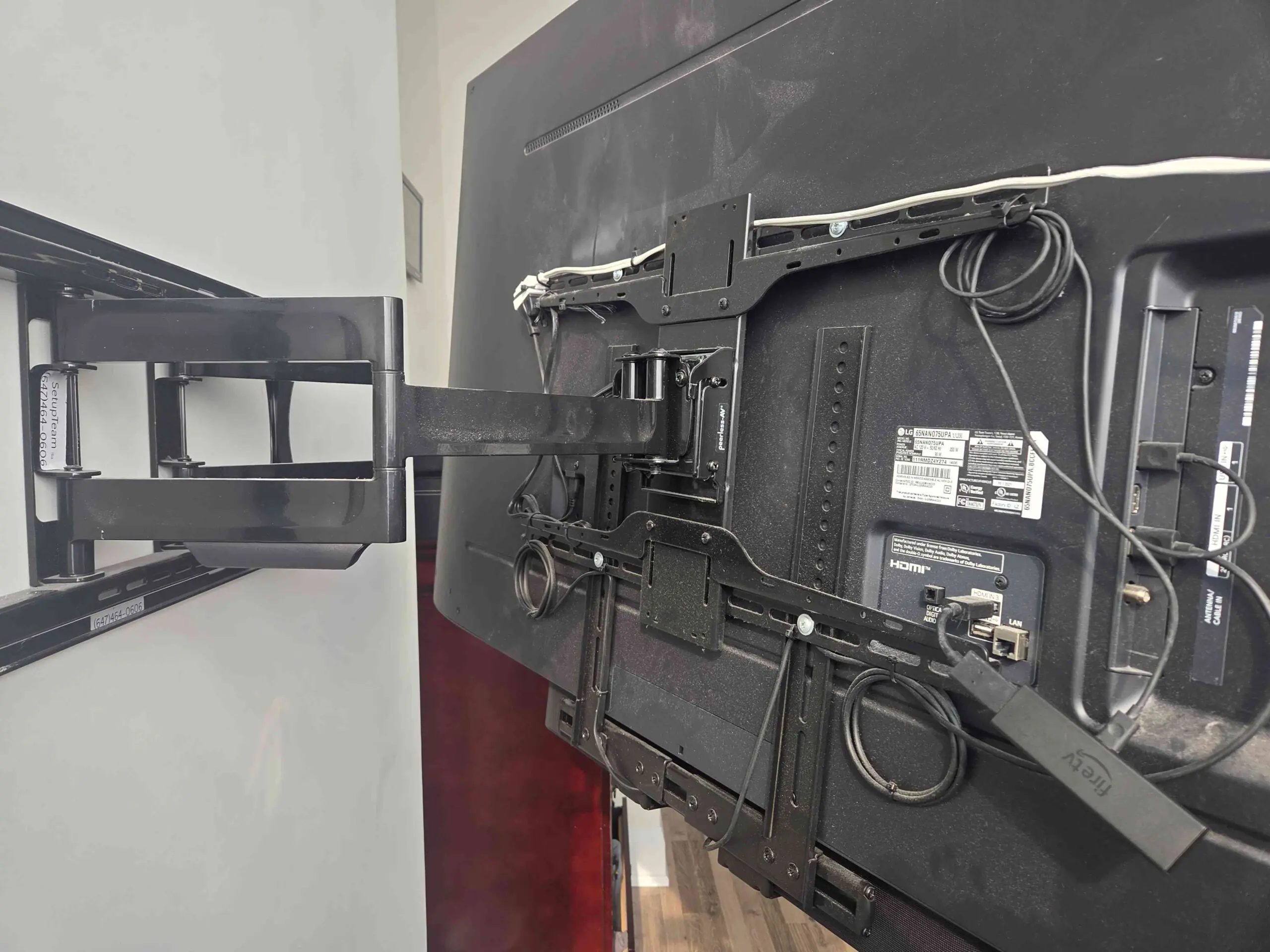 Professional in-wall cable management behind a wall-mounted TV in a condo