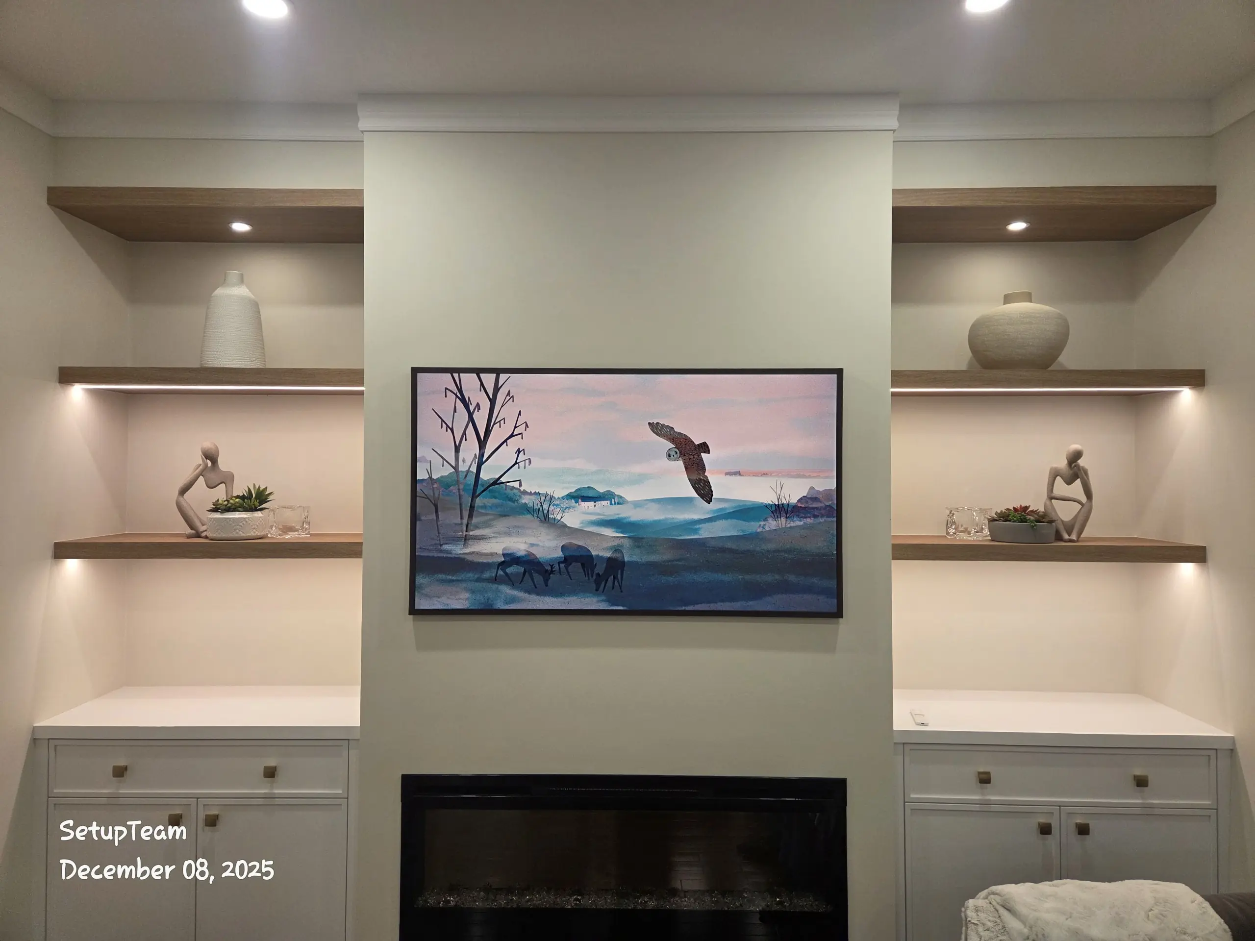 Samsung Frame TV mounted above fireplace with custom built-in shelving — professional installation by SetupTeam Toronto