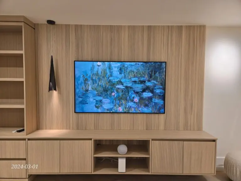 Samsung Frame TV wall mounted on a slat-wood feature wall