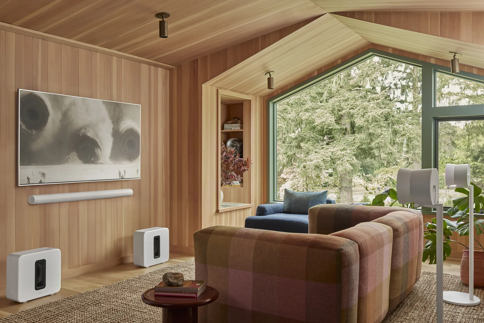 Sonos Arc Ultra in white set up in a wood-panelled cabin-style home theatre