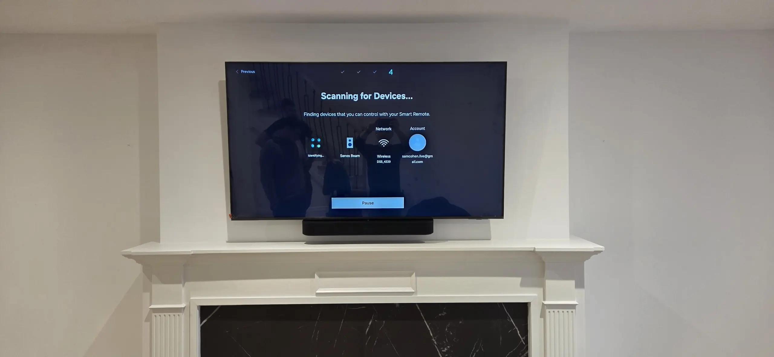 TV above fireplace with soundbar, cables hidden