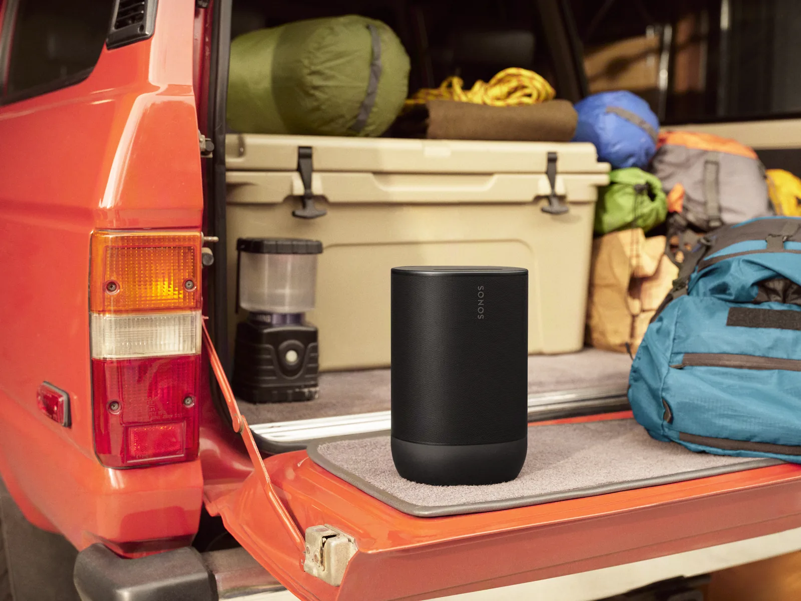 Sonos Move 2 portable speaker in the back of a truck at a campsite