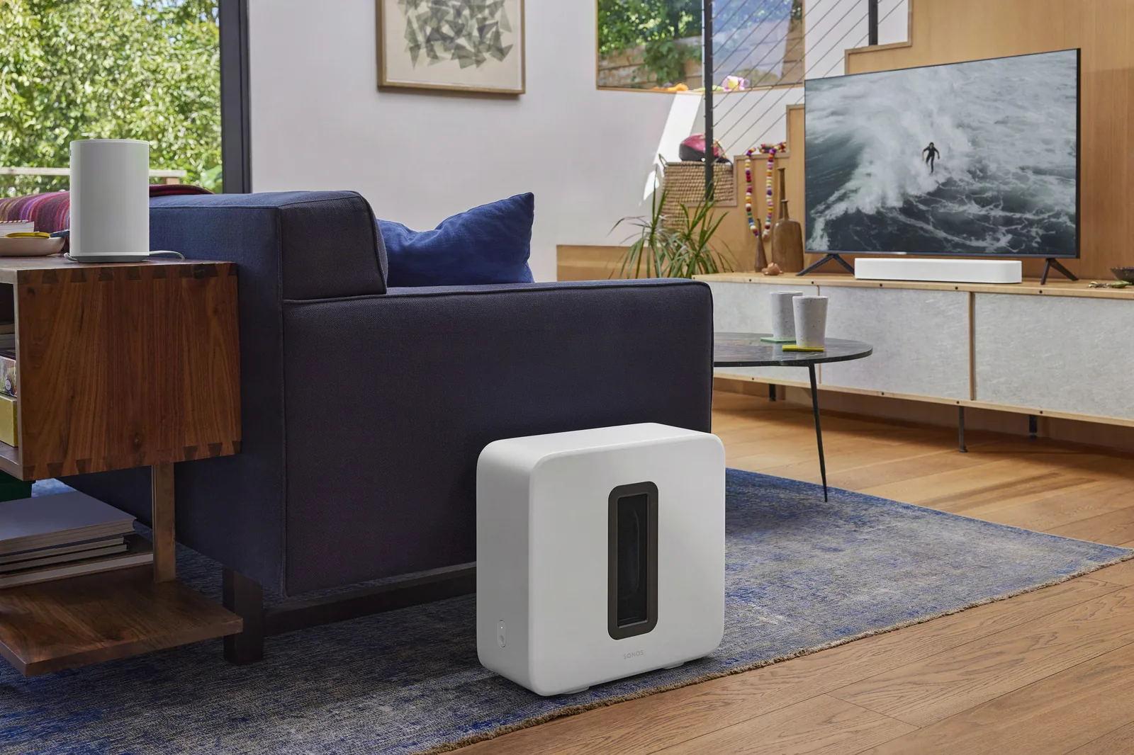 Sonos Sub and Era 100 speaker in white in a bright living room