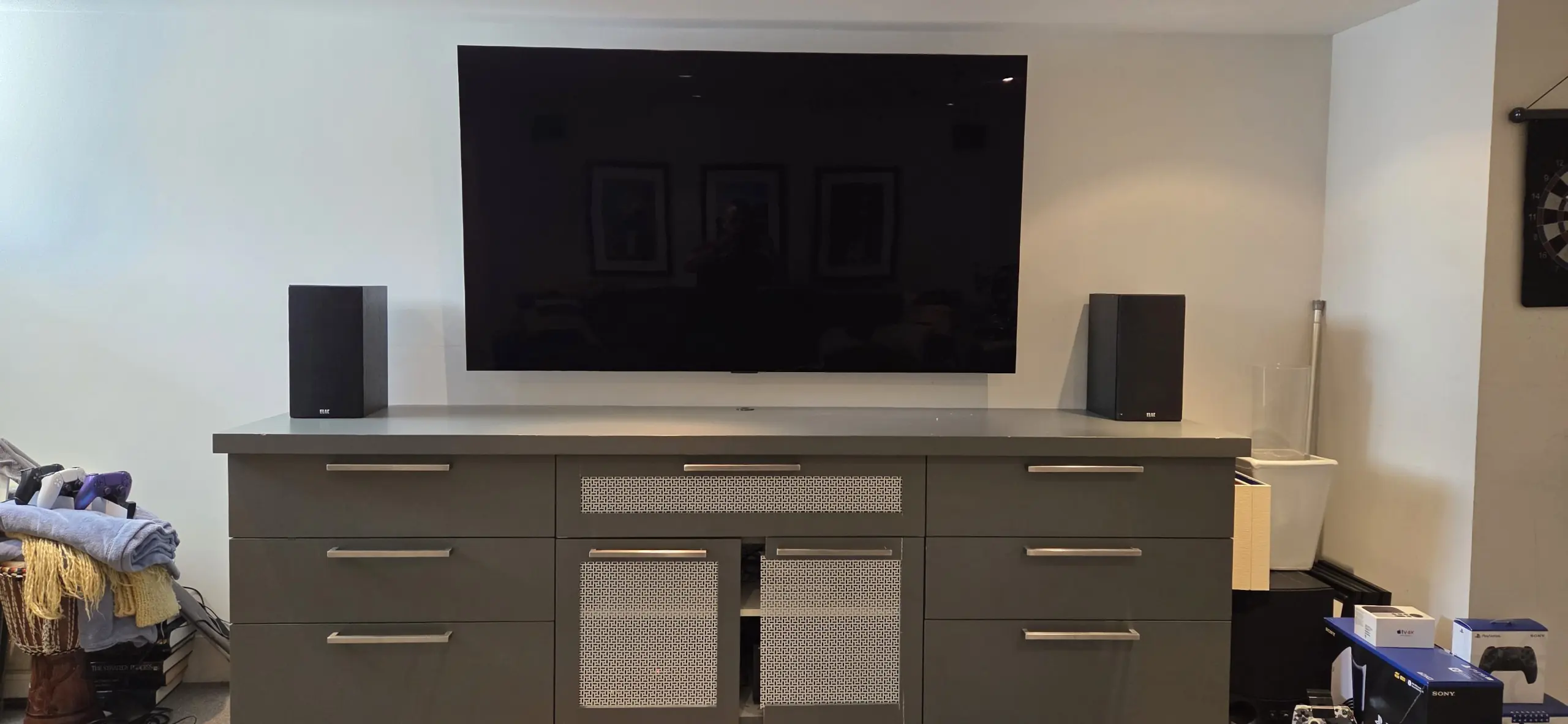 LG OLED above media cabinet, home theatre speakers on each side