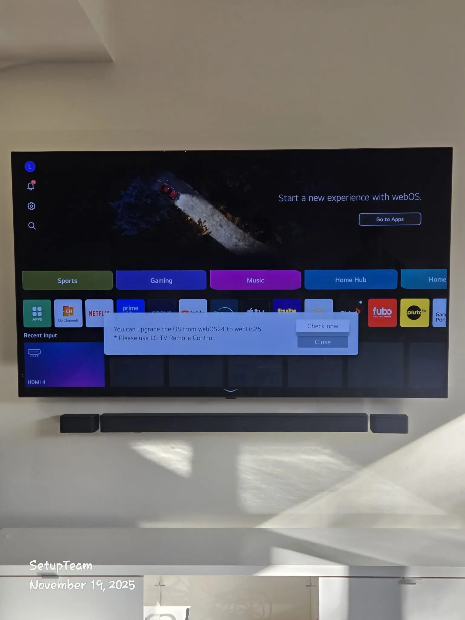 LG OLED television with soundbar mounted on a feature wall