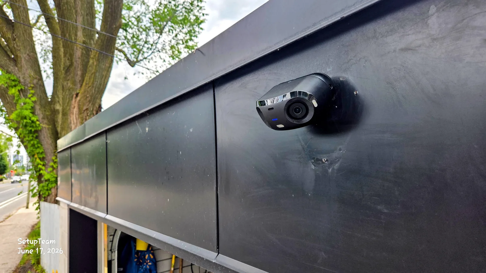 UniFi G6 180 wide-angle security camera installed on an exterior wall, positioned for wide 180-degree street and frontage coverage