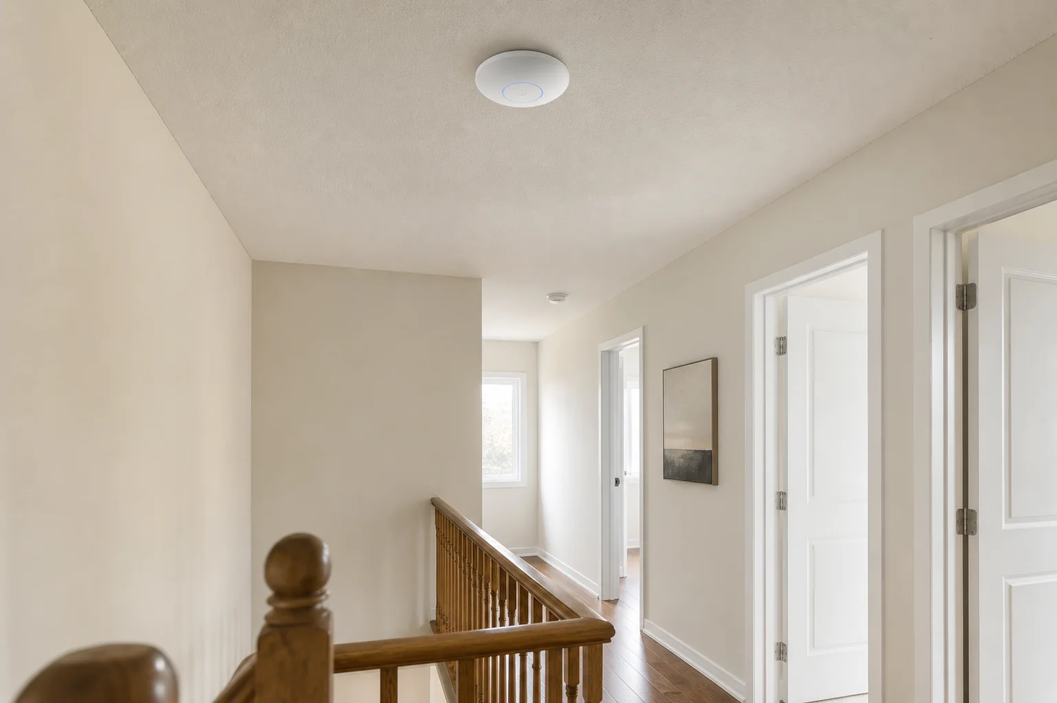UniFi U7 Pro access point ceiling-mounted in the upper hallway of an Erin Mills 1980s planned-suburb two-storey detached home in Mississauga