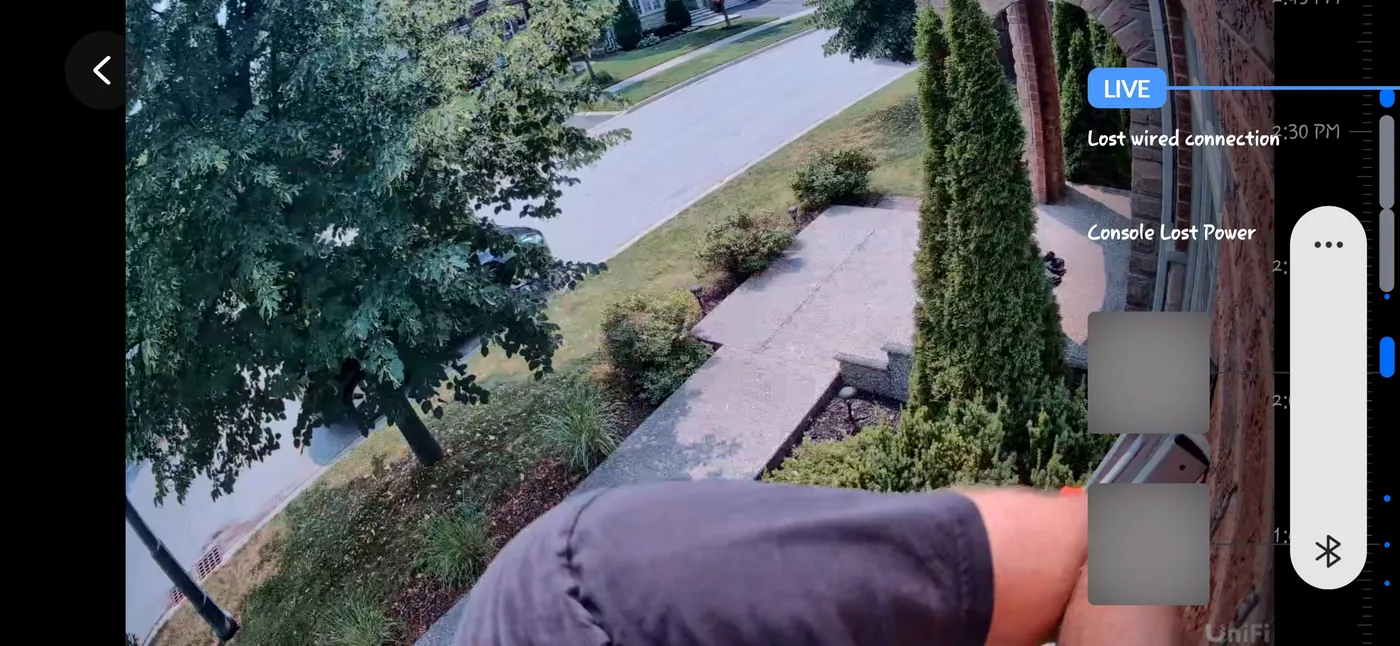 Live view from a UniFi Protect G6 camera during commissioning, showing driveway and front-walk coverage being checked in the UniFi Protect app before final aim