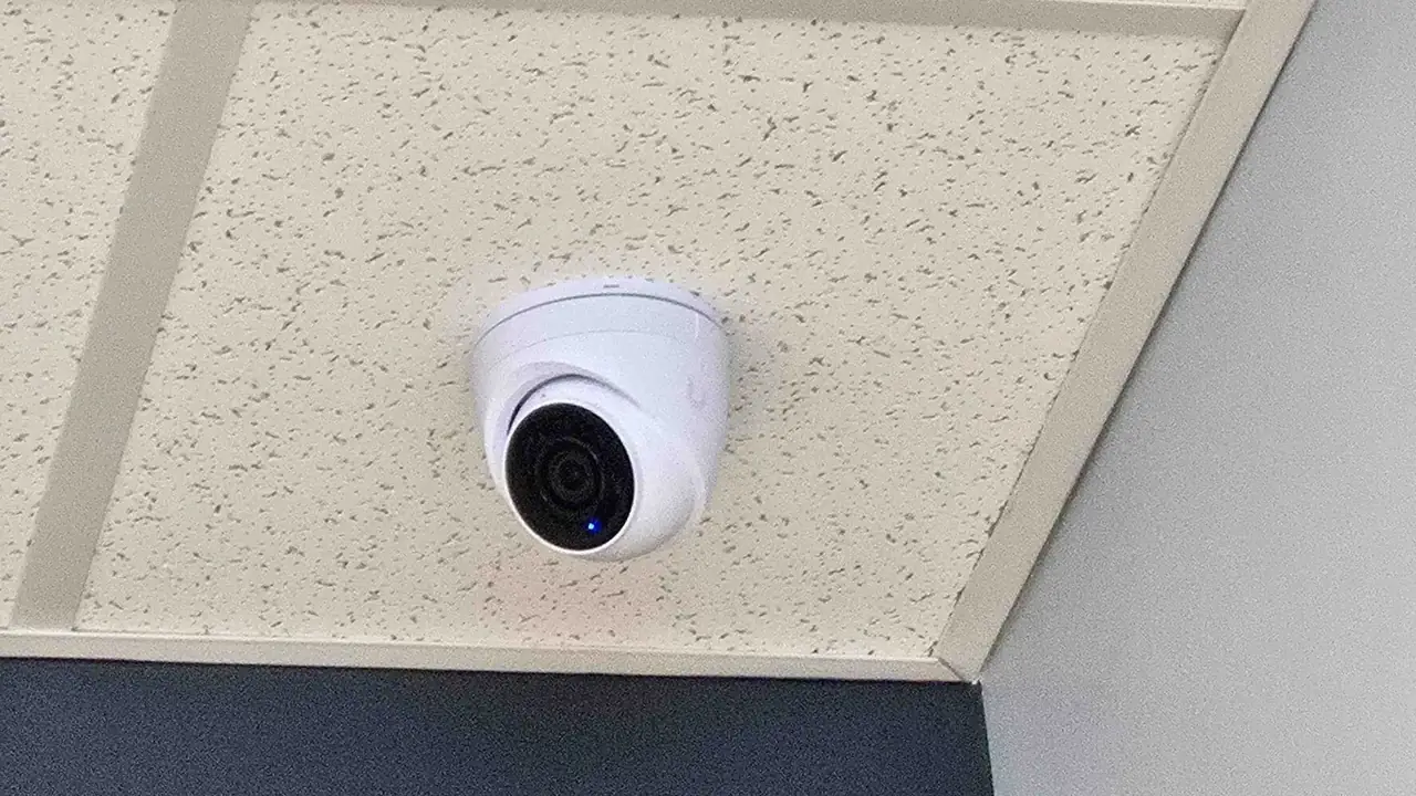 UniFi Protect dome camera mounted in a commercial drop ceiling