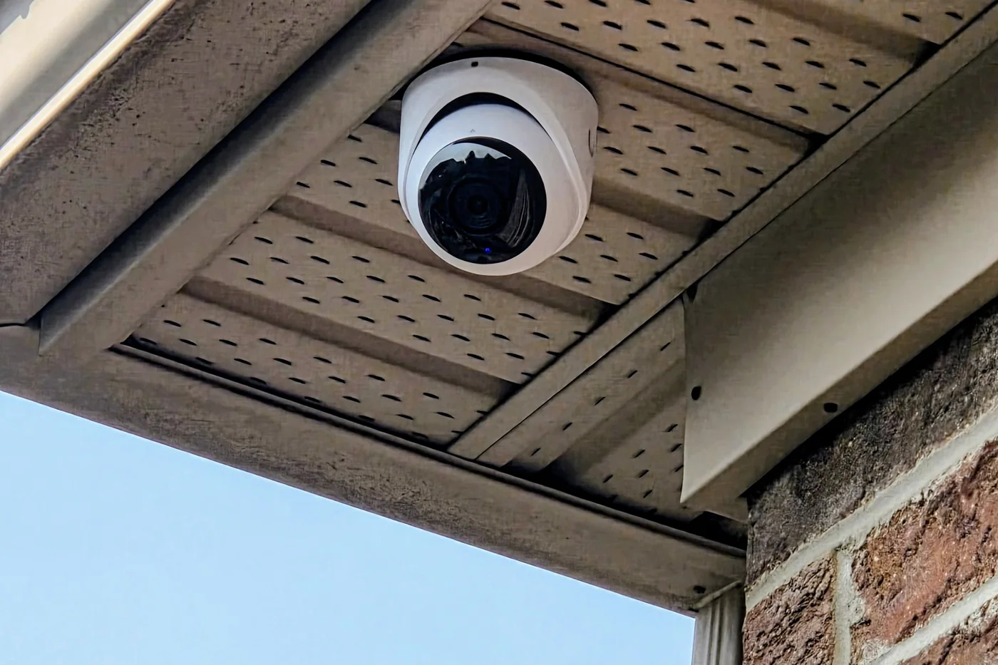 UniFi Protect G6 Turret camera mounted flush under the soffit of an Oakville home with the PoE cable concealed inside the soffit cavity