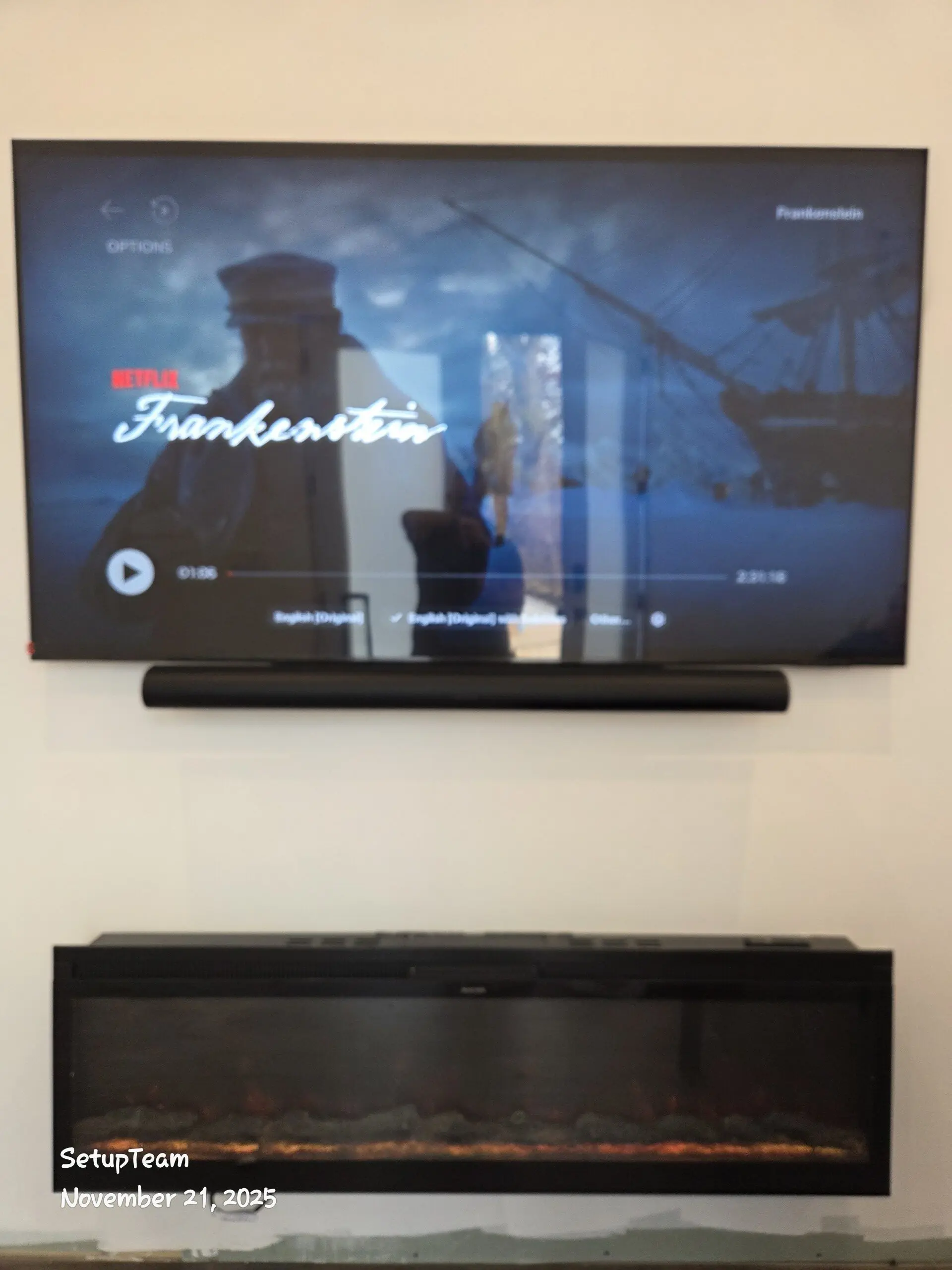 TV mounted above stone fireplace in Woodbridge Vaughan custom home, cables fully hidden, masonry anchors used