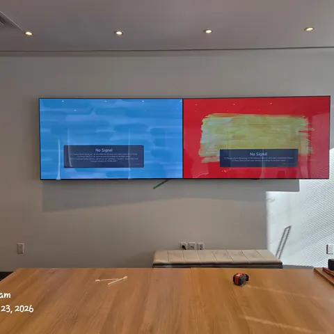 Dual display boardroom installation with commercial meeting room screens for a modern office conference space in Toronto.
