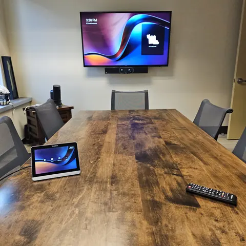 Professional conference room AV installation with Yealink video conferencing system, commercial display, and meeting room integration in Newmarket.