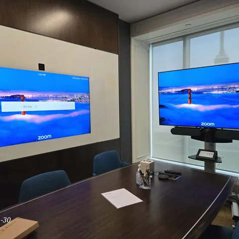 Logitech Rally dual display video conference installation for a professional office boardroom in Toronto.