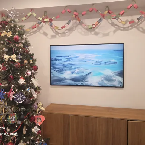 Samsung Frame TV wall mounting installation with concealed wiring above a modern wood media cabinet in Newmarket.