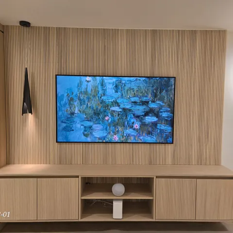 Modern Frame TV wall mounting installation on a custom wood slat feature wall with concealed wiring and built-in cabinetry in Newmarket.