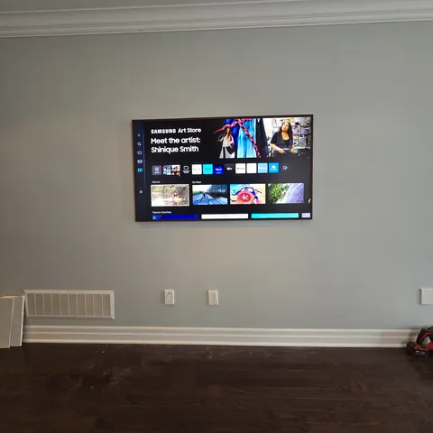 Samsung Frame TV wall mounting installation with concealed wiring and flush-fit setup in a modern condo completed by SetupTeam in Toronto.