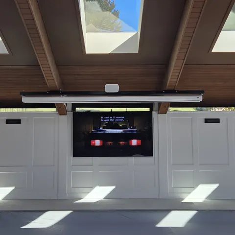 Luxury indoor pool home theater installation featuring a 98-inch TV, motorized projection screen, and dedicated 5.1 surround sound system completed by SetupTeam in Oakville.
