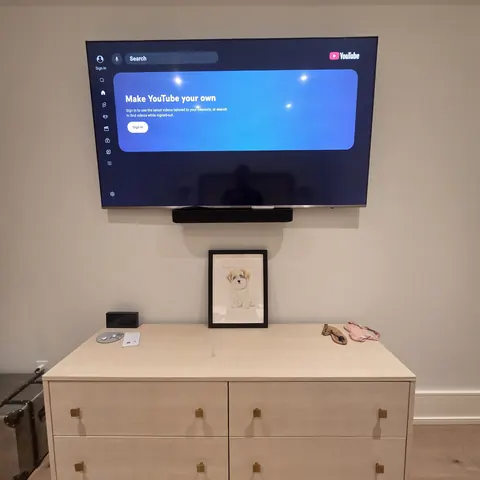 Bedroom TV wall mounting installation with soundbar setup and concealed wiring above a modern dresser in Newmarket.
