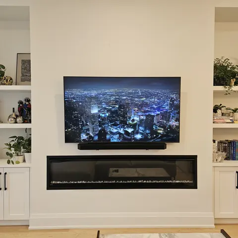 Professional TV wall mounting and soundbar installation above a modern linear fireplace in Vaughan.