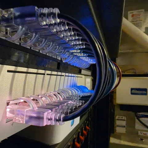 UniFi network switch and organized Ethernet cabling inside a residential network rack installed by SetupTeam in Markham, Ontario, Canada.