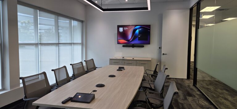 Office Zoom room with a wall-mounted TV display for video conferencing