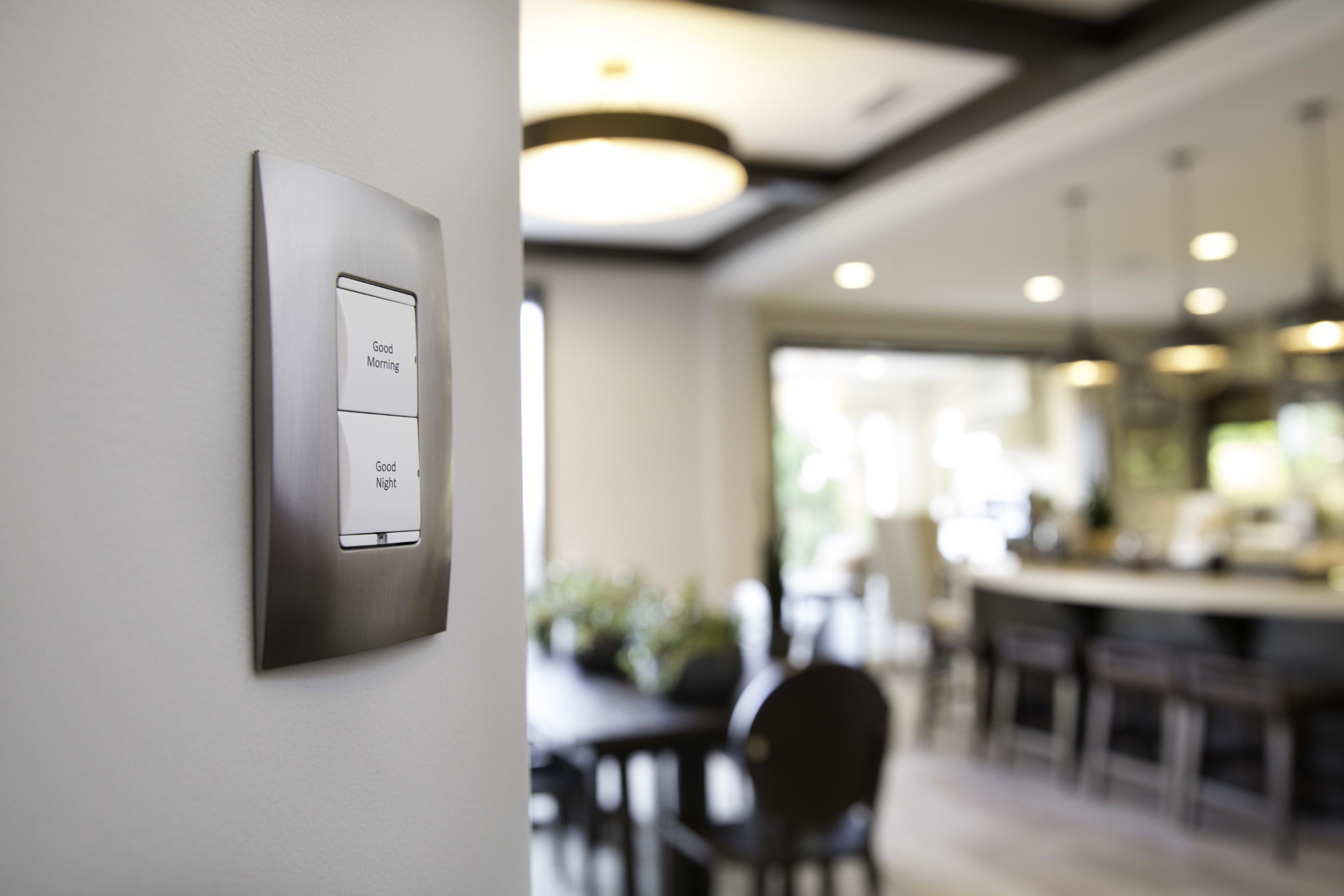 Wall-mounted smart lighting keypad in a modern home