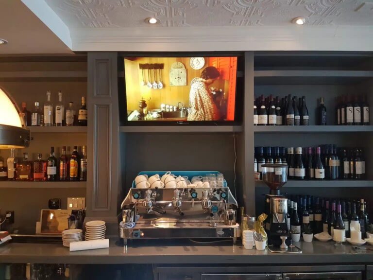 Commercial TV wall mounting above a bar in downtown Toronto