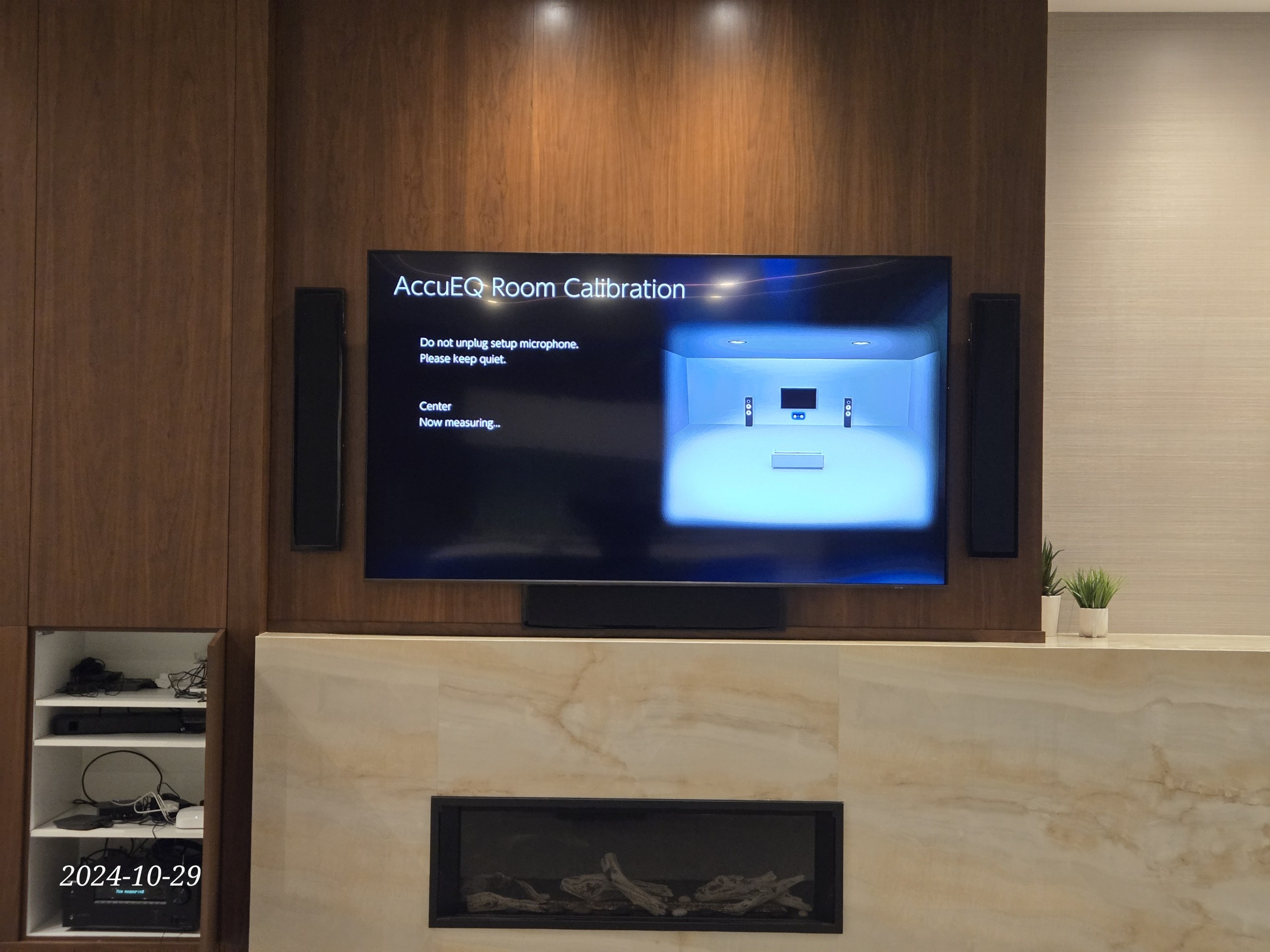 Control4 home theater room with calibrated TV mount above fireplace and in-wall speakers — SetupTeam Toronto