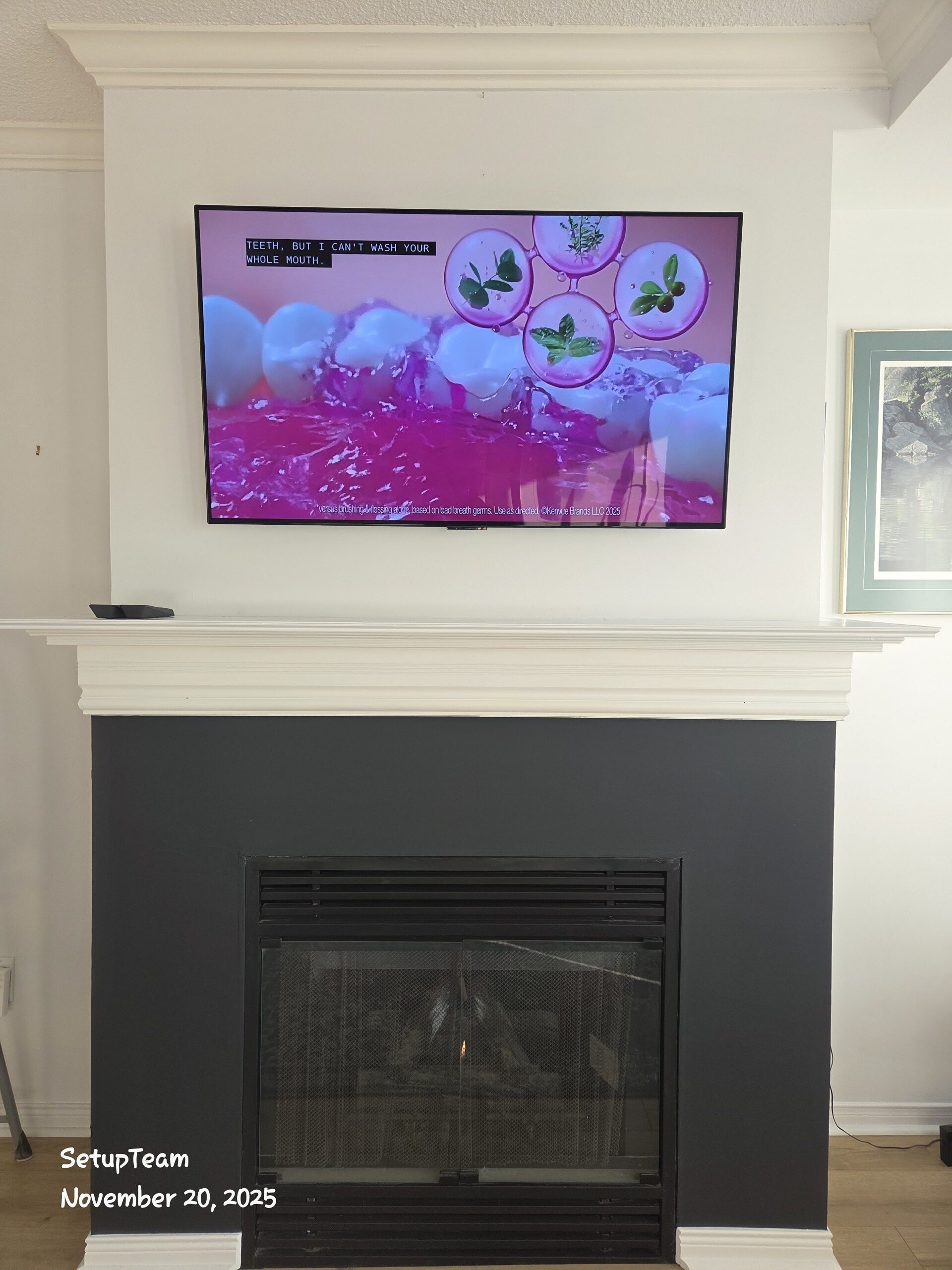 TV wall mounted above a fireplace with cables concealed behind the wall in a Gormley home north of Toronto