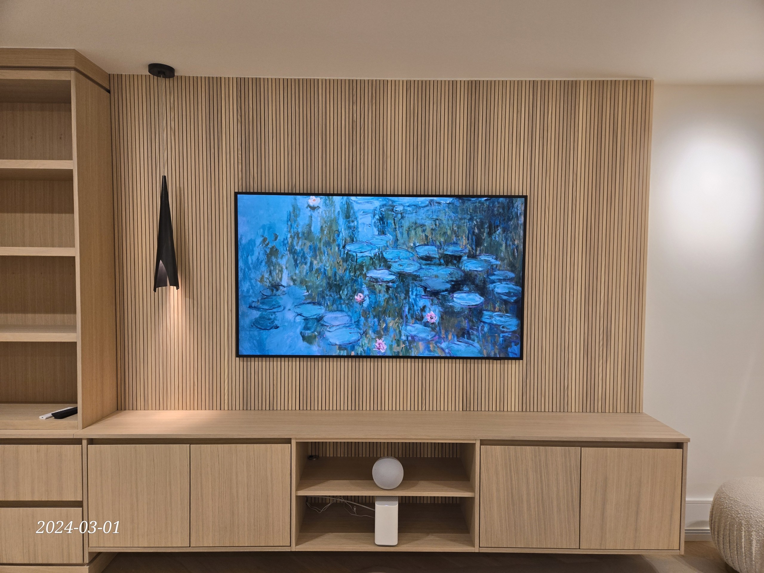 65-inch OLED TV wall mount on slat-wood feature wall