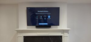TV installation above a fireplace with a clean, centered layout