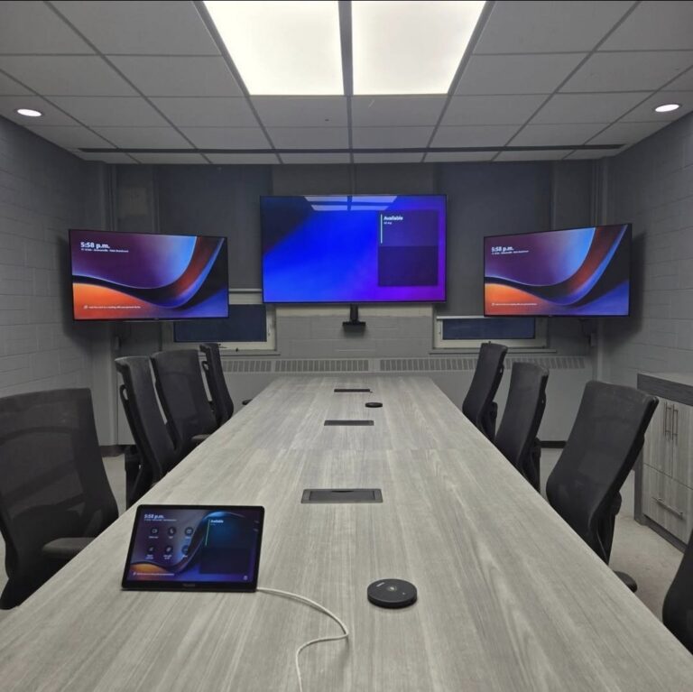 Conference room video conferencing setup with three wall-mounted tv's