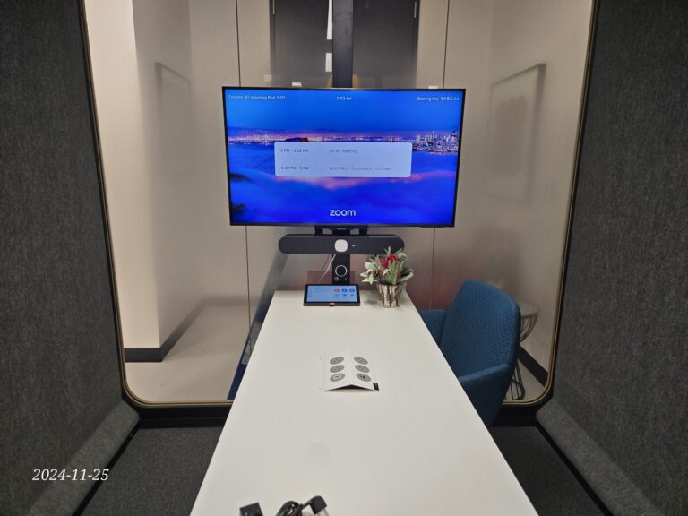 Office meeting pod with a wall-mounted TV set up for video conferencing