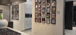 Professional Custom Picture Collage & Gallery Wall Installation Professional picture collage creating a stunning gallery wall in a modern kitchen. Meticulous art installation and precision picture hanging services by Setup Team in the GTA.