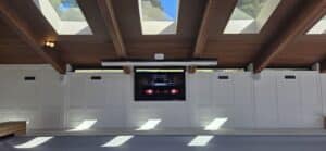 Custom Indoor Pool Home Theater with Dual Screens and Control4 Automation Luxury indoor pool home theater featuring a 98-inch TV and a ceiling-mounted projector with a motorized screen. Custom installation and Control4 smart home automation by Setup Team in the GTA
