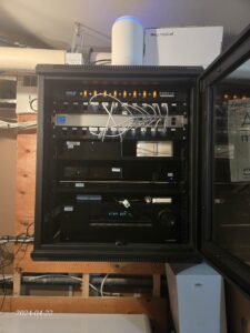 Residential network rack with patch panel and labeled Cat6 terminations for structured wiring in a Toronto home