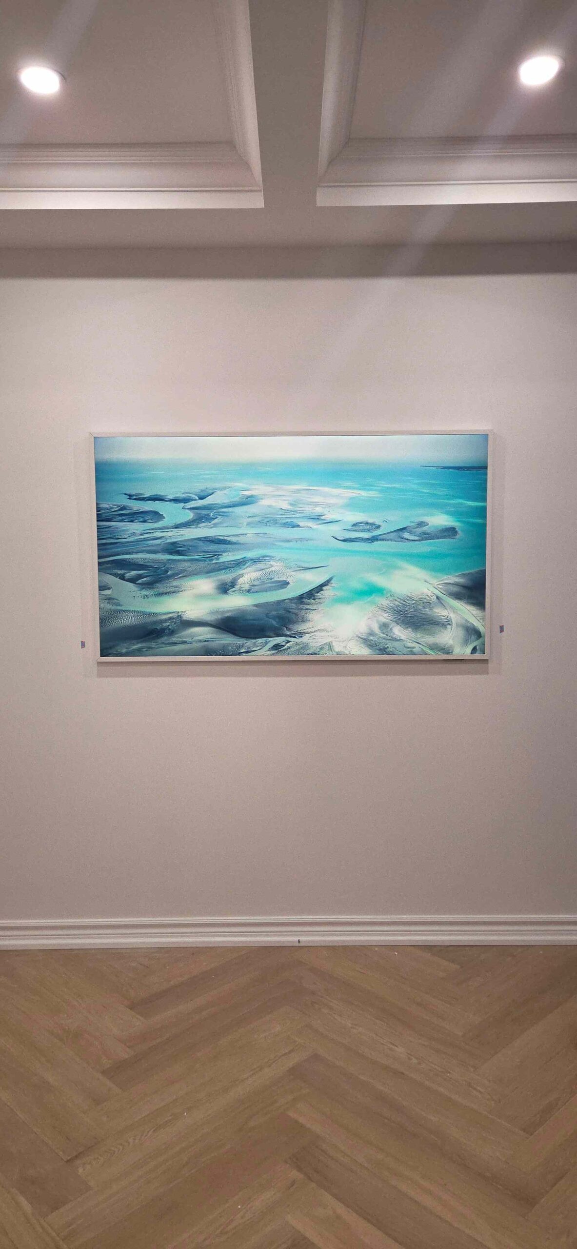 65-inch Samsung Frame TV with custom white bezel installation