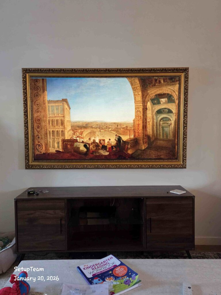 Samsung Frame TV with a custom bezel displaying artwork above a media console in a living room