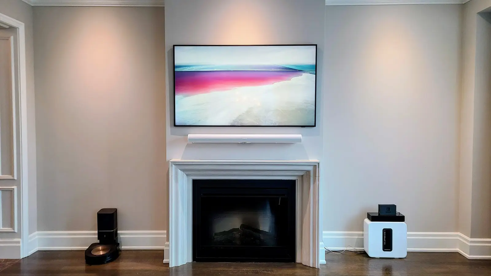 Samsung Frame TV and Sonos Arc mounted above a fireplace