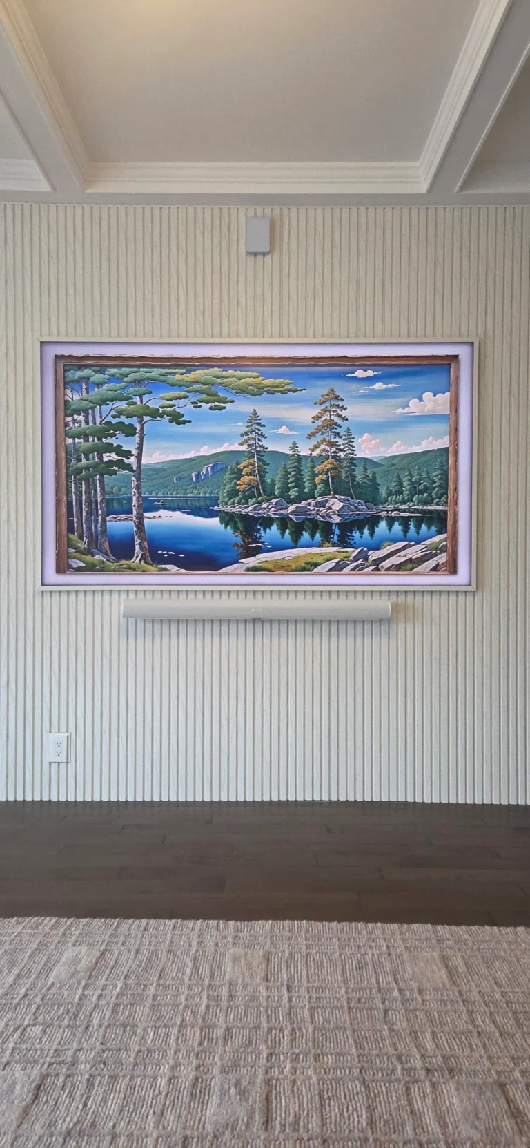 Samsung Frame TV displaying landscape artwork with soundbar mounted below on textured feature wall with concealed wiring