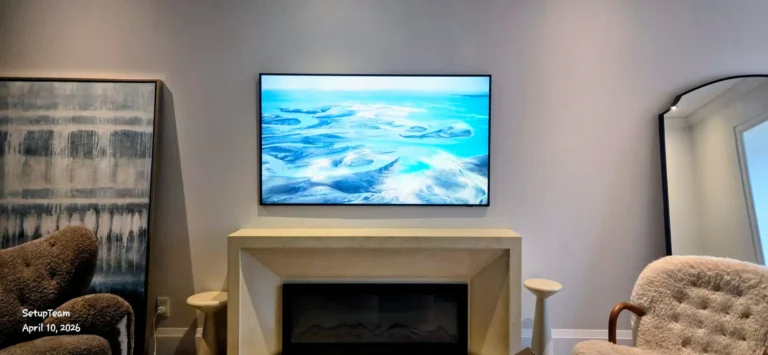 Samsung Frame TV mounted above a fireplace in a modern residential living room
