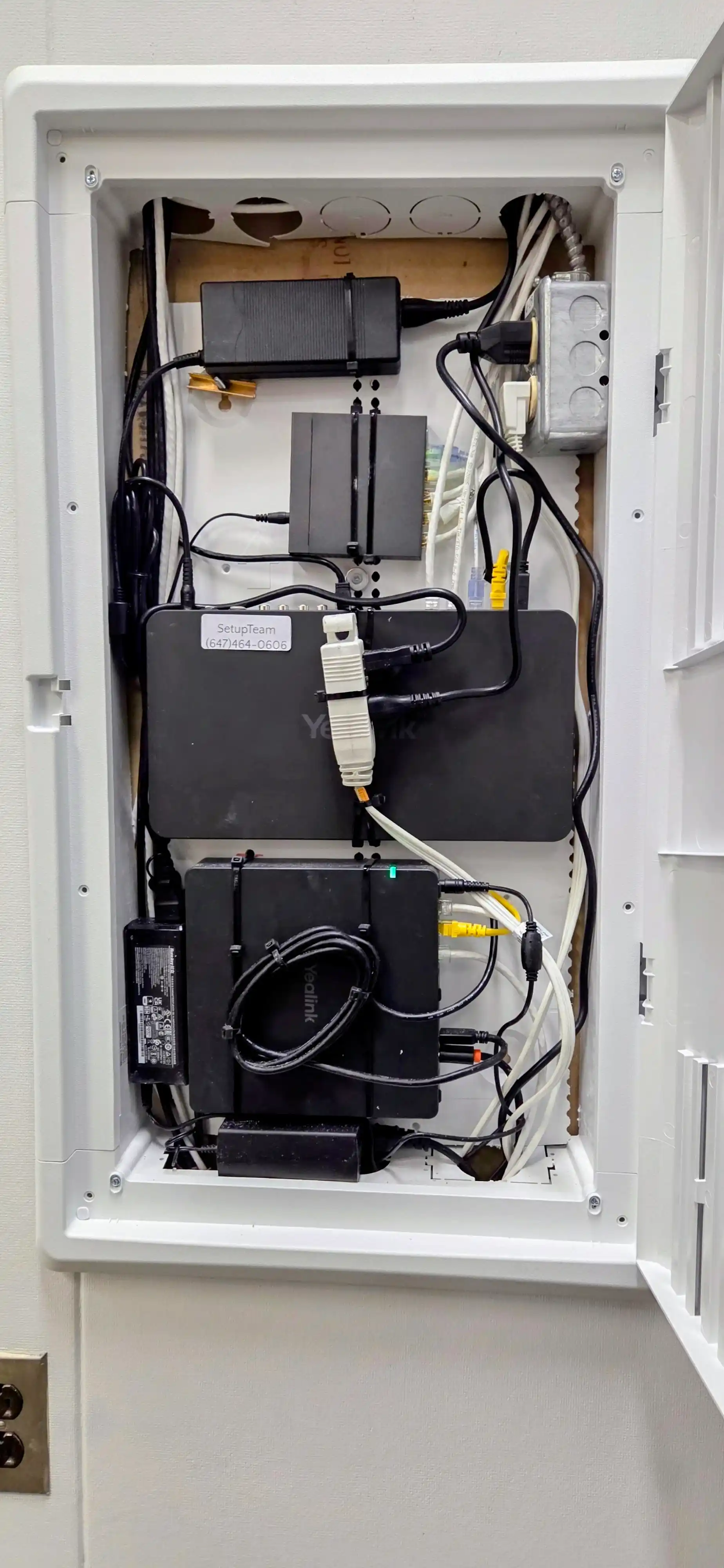 Clean conference room cable management — labeled Ethernet and surface raceway