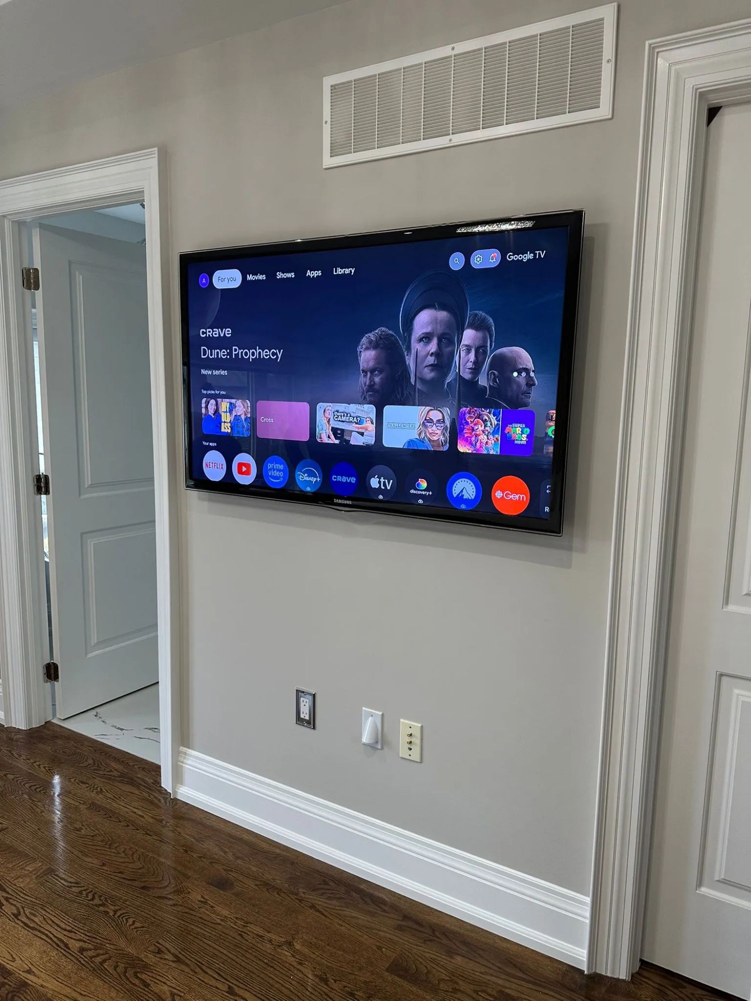 Flush wall-mounted TV in a modern Toronto condo living room with hidden cables