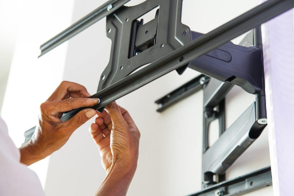 Man installing TV wall mount